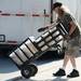 Artist Wayne Dorn, of Louisville, wheels supplies to his tent as he sets up for his recycled metal yard sculptures business, Yard Birds on E. Liberty St in downtown Ann Arbor on Tuesday morning, July 16, 2013. Melanie Maxwell | AnnArbor.com